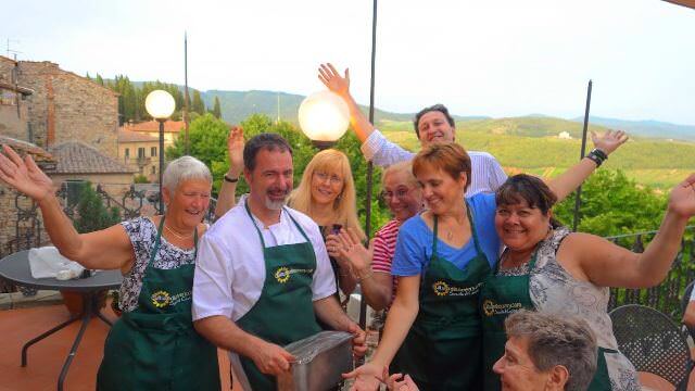 Enjoying a small-group hands-on cooking class and wonderful meal with friends overlooking the Tuscan landscape